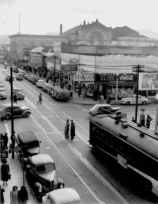 Fillmore Street from above, busy with streetcars, shoppers and storefront signs